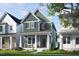 Charming two-story home showcasing a covered front porch, manicured lawn, and vibrant landscaping at 1905 Plott Balsam Dr, Wendell, NC 27591