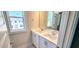 Modern bathroom featuring a double vanity, clean tile, and natural lighting at 1905 Plott Balsam Dr, Wendell, NC 27591