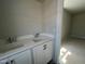 Bright bathroom featuring double sinks with modern faucets, and a doorway to the spacious bedroom at 1905 Plott Balsam Dr, Wendell, NC 27591