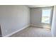 Cozy bedroom with neutral carpet, white trim, and a bright window offering nice views at 1905 Plott Balsam Dr, Wendell, NC 27591