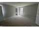 Spacious bedroom featuring neutral walls, a window, and ensuite bathroom access, awaiting personalization at 1905 Plott Balsam Dr, Wendell, NC 27591