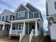 Charming two-story home featuring light green siding, white trim, a cozy front porch, and a welcoming entrance at 1905 Plott Balsam Dr, Wendell, NC 27591