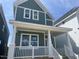 Attractive two-story home showcasing green siding, white trim, and a covered porch perfect for enjoying outdoor living at 1905 Plott Balsam Dr, Wendell, NC 27591