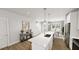 Modern kitchen with a central island, contemporary lighting, and a seamless flow into the dining and living areas at 1905 Plott Balsam Dr, Wendell, NC 27591