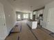 Spacious kitchen featuring an island, modern lighting, and cabinetry awaiting appliances, and final touches at 1905 Plott Balsam Dr, Wendell, NC 27591
