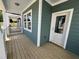 View of the home's wooden porch, featuring green siding, white trim, and a welcoming entryway at 1905 Plott Balsam Dr, Wendell, NC 27591