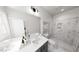 Modern bathroom with marble walk-in shower and dual vanities with sleek fixtures at 1907 Plott Balsam Dr, Wendell, NC 27591