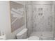 Modern bathroom featuring glass shower with marble-like tile, toilet, and neutral artwork at 1907 Plott Balsam Dr, Wendell, NC 27591