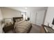 Neutral bedroom features a bed with wooden headboard and two side tables with lamps at 1907 Plott Balsam Dr, Wendell, NC 27591