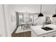 Elegant dining room with modern lighting and decor adjacent to a well-equipped kitchen at 1907 Plott Balsam Dr, Wendell, NC 27591