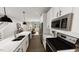 Bright, open kitchen with white cabinets, stainless steel appliances, and hardwood flooring at 1907 Plott Balsam Dr, Wendell, NC 27591