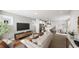 Open-concept living room with hardwood floors, modern furniture, and plenty of natural light at 1907 Plott Balsam Dr, Wendell, NC 27591