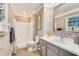 Updated bathroom with a tub, shower, grey vanity, and stylish mirror at 201 Lake St, Fuquay Varina, NC 27526