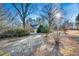 Scenic exterior shot of home featuring mature trees and a circular driveway at 201 Lake St, Fuquay Varina, NC 27526