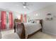 Cozy bedroom with warm-toned walls, decorative moon phases, two windows, and pink blackout curtains at 2015 Pratt Cir, Franklinton, NC 27525