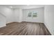 Spacious living area featuring hardwood flooring and abundant natural light, leading to a staircase at 2058 Glen Crossing Dr, Durham, NC 27704