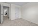 Neutral bedroom with plush carpet, white walls, and a door to the hallway at 2117 Trailside Dr, Durham, NC 27704