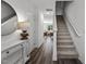 Inviting entryway with wood floors, stairs, console table and access to the living area at 2117 Trailside Dr, Durham, NC 27704