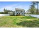 Expansive, fenced backyard with a spacious lawn and a small deck, ideal for relaxation and entertainment at 220 Green Haven Blvd, Youngsville, NC 27596
