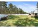 Grassy backyard featuring a white fence and plenty of space for outdoor activities and enjoyment at 220 Green Haven Blvd, Youngsville, NC 27596