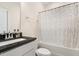 Bathroom features a vanity with black countertop and shower with white patterned shower curtain at 220 Green Haven Blvd, Youngsville, NC 27596
