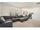 Comfortable bonus room with large gray sectional sofa and a workspace at 220 Green Haven Blvd, Youngsville, NC 27596