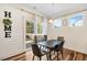 Charming dining area with a modern table, chairs, and natural light from the large windows at 220 Green Haven Blvd, Youngsville, NC 27596