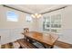 Inviting dining room with natural light, rustic wooden table, bench seating, and modern light fixture at 220 Green Haven Blvd, Youngsville, NC 27596