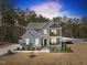 Charming two-story home with gray siding, stone accents, and inviting front porch and balcony at 220 Green Haven Blvd, Youngsville, NC 27596