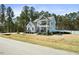 Attractive two-story home with gray siding, stone accents, and inviting front porch and balcony at 220 Green Haven Blvd, Youngsville, NC 27596