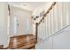 Bright foyer with hardwood floors, elegant staircase, and a stylish front door with glass panels at 220 Green Haven Blvd, Youngsville, NC 27596