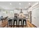 Modern kitchen featuring a spacious island with black countertop, white cabinets, and stainless steel appliances at 220 Green Haven Blvd, Youngsville, NC 27596