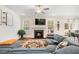 Inviting living room with a fireplace, plush sofa, and an open layout leading to the dining area at 220 Green Haven Blvd, Youngsville, NC 27596