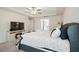 Comfortable main bedroom with tray ceiling, tv and a neutral color palette at 220 Green Haven Blvd, Youngsville, NC 27596