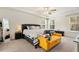 Bright main bedroom with tray ceiling, bench, and carpet at 220 Green Haven Blvd, Youngsville, NC 27596