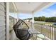 View of cozy porch with chair, table and railing at 220 Green Haven Blvd, Youngsville, NC 27596