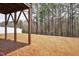 View from under the back deck, showcasing the spacious backyard with a line of trees in the distance at 240 Amber Acorn Ave, Raleigh, NC 27603