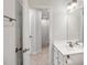 Bright bathroom showcasing a modern vanity with sleek fixtures, open doorway, and neutral-colored walls at 240 Amber Acorn Ave, Raleigh, NC 27603