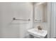 Modern bathroom featuring a stylish pedestal sink with brushed fixtures and towel bar against neutral walls at 240 Amber Acorn Ave, Raleigh, NC 27603