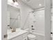 Well-lit bathroom featuring modern vanity with a sleek white sink and tub/shower with updated fixtures at 240 Amber Acorn Ave, Raleigh, NC 27603