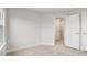 Bright, carpeted bedroom with neutral decor and open doorway to the hall at 240 Amber Acorn Ave, Raleigh, NC 27603