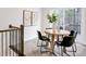 Cozy dining area with contemporary table and chairs, artwork, and natural light from sliding glass doors at 240 Amber Acorn Ave, Raleigh, NC 27603