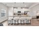 Well-lit kitchen with stainless steel appliances, granite countertops, and an island with barstool seating at 240 Amber Acorn Ave, Raleigh, NC 27603
