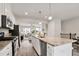 Spacious kitchen featuring granite countertops, stainless steel appliances, and an open view to the living area at 240 Amber Acorn Ave, Raleigh, NC 27603