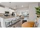 Open floor plan connecting kitchen to living area with granite countertops and stainless steel appliances at 240 Amber Acorn Ave, Raleigh, NC 27603