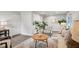 Comfortable living room with accent chair, neutral decor, and wood-look floors at 240 Amber Acorn Ave, Raleigh, NC 27603