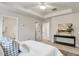 Bright main bedroom featuring a tray ceiling, neutral decor, and doorway at 240 Amber Acorn Ave, Raleigh, NC 27603