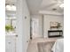 Bright main bedroom with a plant on a console table, neutral decor, and doorway to bathroom at 240 Amber Acorn Ave, Raleigh, NC 27603