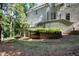 Secluded backyard with mature trees, landscaped beds, and a lower level patio at 2658 Davis St, Raleigh, NC 27608
