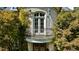 Close up of a curved balcony featuring a wrought iron railing and light blue trim at 2658 Davis St, Raleigh, NC 27608